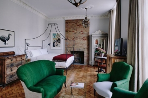 artists residence bedroom with green armchairs