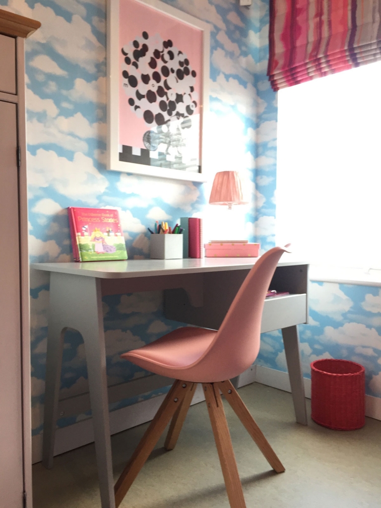 Simple shaped furniture and modern graphic prints keep the look cute and not too frilly