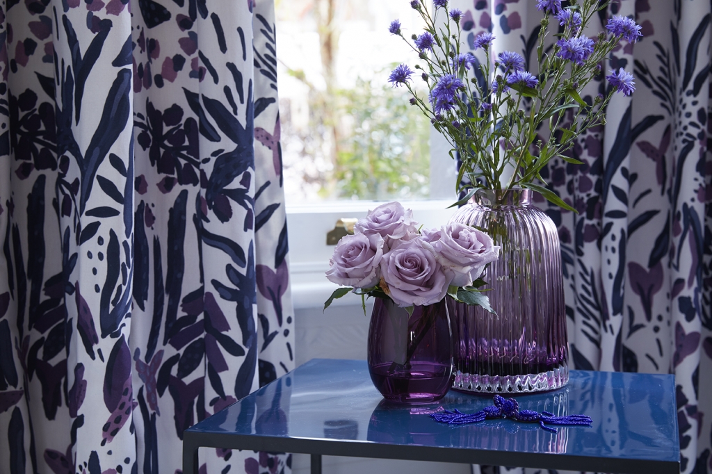 pantone of colour of the year 2018 is utra violet a bright and intense purple. lilac coloured rsoses and intense purple flowers in vases create the look