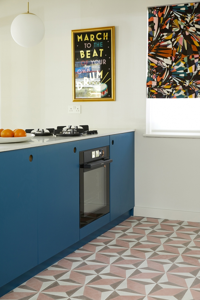 Interior deisgner Sophie robinson designed this marine blue kitchen with pink outra cement tiles from Bert and may. 